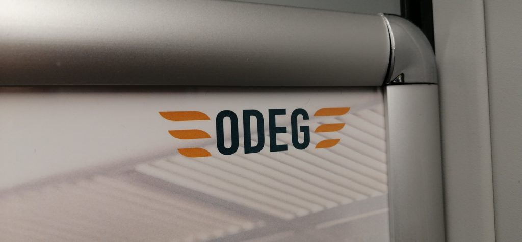 Das ODEG-Signet in der Ecke eines Plakats in einem silberfarbenen Rahmen in einem ODEG-Zug am Tag vor dem 6-Tage-Streik der Lokführer bei der Bahn.